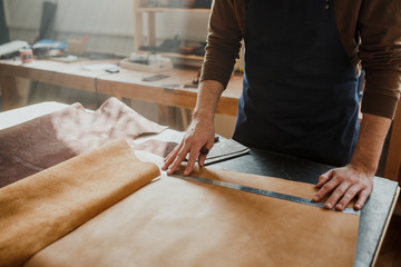 Close-up. Male hand master tanner in an apron for the work with