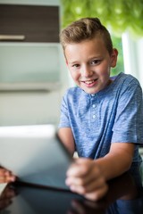 Portrait of boy using digital tablet