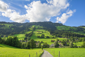 Fototapeta na wymiar Country road in Brixental Valley in Tirolean Alps, Austria, popular summer and winter location for tourism .