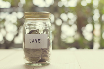 Money in the glass jar for saving money concept with retro effec