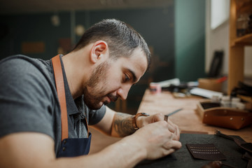 The master tanner in the studio working on the manufacture of pr