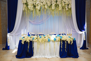Wedding accessories. The decoration of the Banquet Hall. Table newlyweds