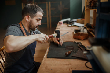 The master tanner in the studio working on the manufacture of pr