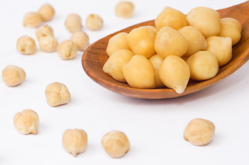 chickpeas over spoon on white background