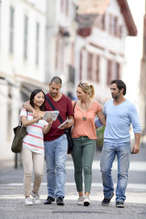 Young people on vacation walking in city street