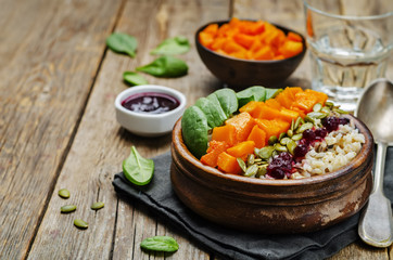 rice bowl with spinach, pumpkin, pumpkin seeds and cranberry sau