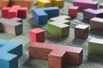 Abstract construction from wooden blocks tetris shapes. The concept of logical thinking, geometric...