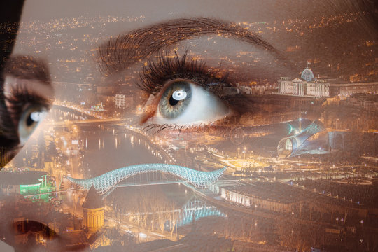 Photo of woman eye and city night lights. Double exposure
