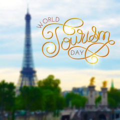 World tourism day hand lettering on blurred photo background
