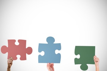 Hands holding puzzle pieces 