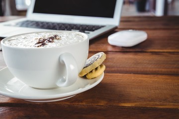 Coffee cup and cookies on a table