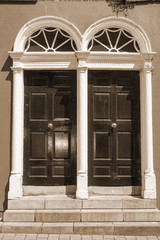 two sepia arched georgian doors