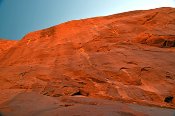 Sun Coming over red cliff in desert