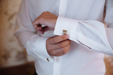 Groom hands with cufflinks. Elegant gentleman clother, white shirt