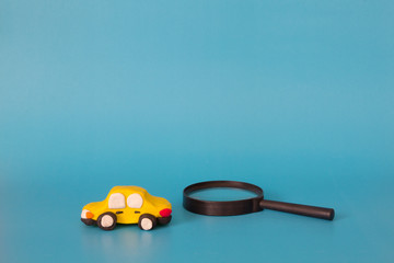 car toy model with magnifying glass , find new car , fixed car service