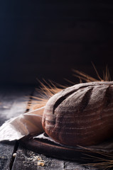 wheat and bread on a wooden table