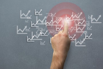 hand pointing at graphs