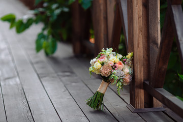 Wedding bouquet. Bride's flowers on wooden background