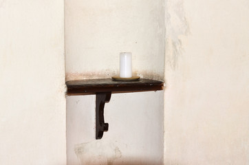 Candle  /  Candle on the old shelf in the church on Zelena hora in Czech Republic