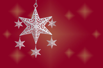 Fototapeta na wymiar White Christmas star ornament on red starry background, with copy space