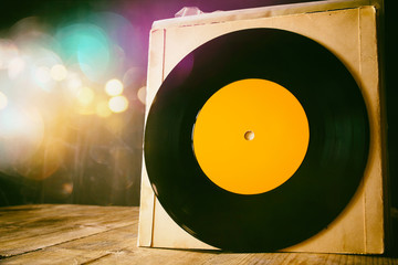 old records on wooden table with glitter background