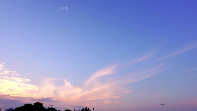 Airplane flying in autumn sunset in slow motion
