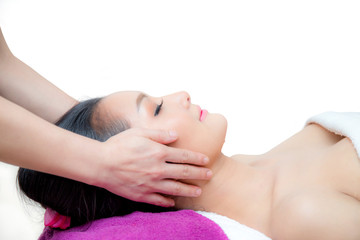 Fototapeta na wymiar Beautiful woman is getting a facial massage in the spa salon