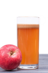 freshly squeezed apple juice in the glass on table isolated