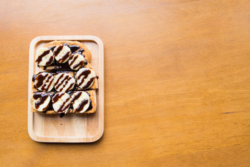 Top view of banana with chocolate on grilled bread on left