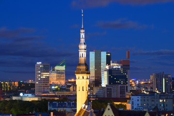 Obraz premium The spire of old city hall on the background of a modern city. Tallinn, Estonia