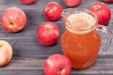 fresh squeezed red apple juice in the pitcher on table