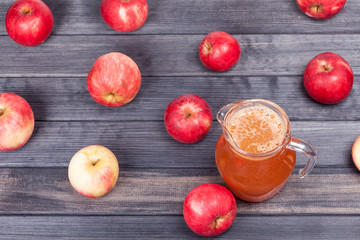 red apples and juice on wooden table top view background