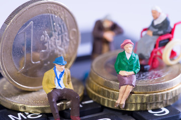 Age poverty / Pensioners sitting on Euro coins