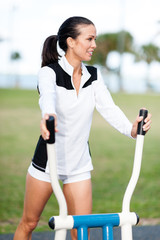 Young Woman Fitness Training on Stair Stepper in Park