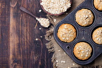 Healthy vegan oat muffins, apple and banana cakes in vintage pan. Top view. Copy space