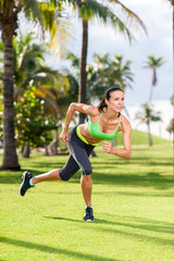 Young woman exercising in tropical park