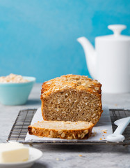 Healthy vegan oat and coconut loaf bread, cake on a cooling rack Grey stone background