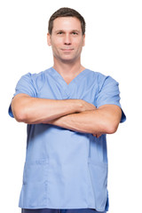 Doctor nurse surgeon with arms crossed on white