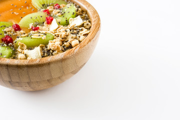 Healthy smoothie with fruit, cereals and chia seeds in a bowl isolated on white background
