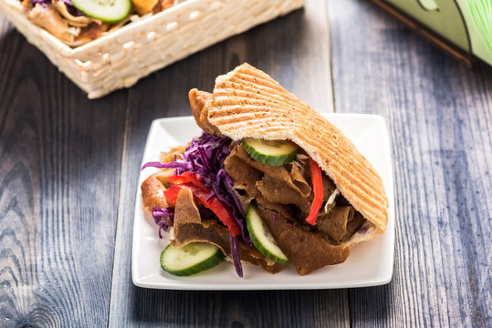 Meat with vegetables in pita bread roll