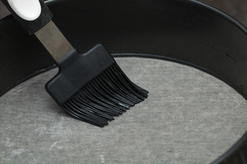 Baking pan grease with a brush.
