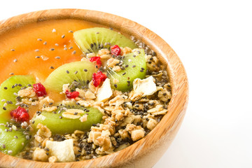 Healthy smoothie with fruit, cereals and chia seeds in a bowl isolated on white background
