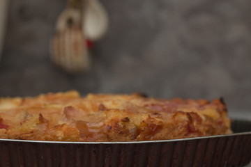 Apple pie on the plate. Golden crust. The interior of the kitchen.
