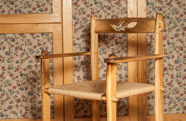 Fototapeta na wymiar vintage wooden chair on a background of an old cabinet