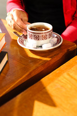 Woman drinking tea at sidewalk cafe