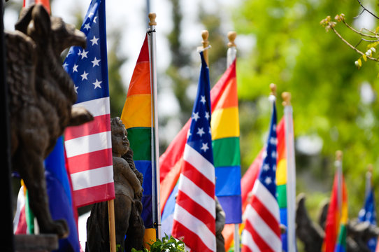 LGBTQ American and Rainbow Pride flags flying together