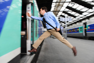 Businessman running to catch train
