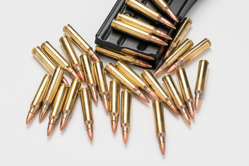 Ammunition in magazine .223/556 isolated a on white surface.