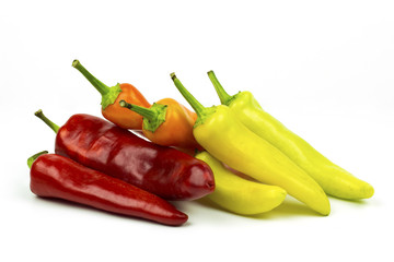 Group of orange, yellow, green and red peppers isolated on white