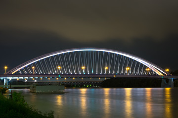 Fototapeta na wymiar Apollo Bridge in Bratislava Slovakia with reflections in river Danube
